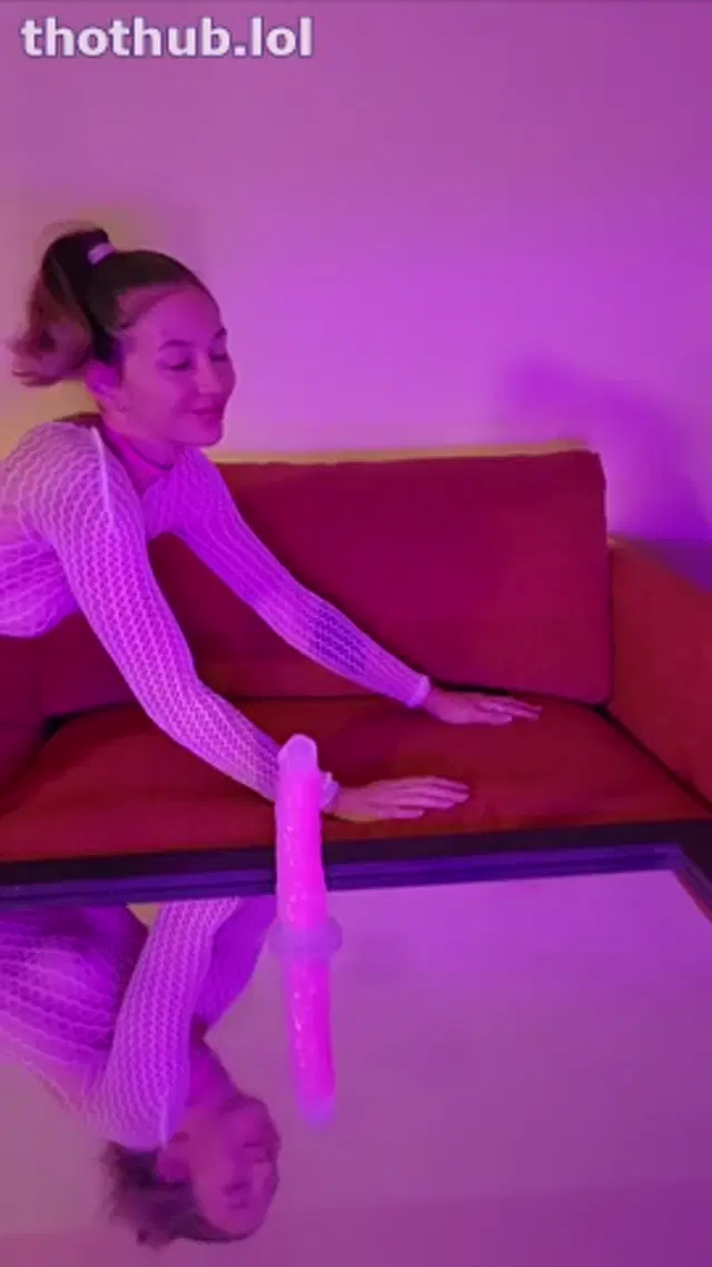 Alicenz rides her toy in white fishnets under pink lights
