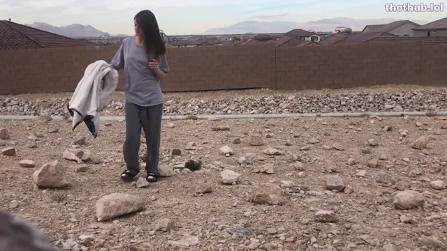Three girls outside in the desert peeing