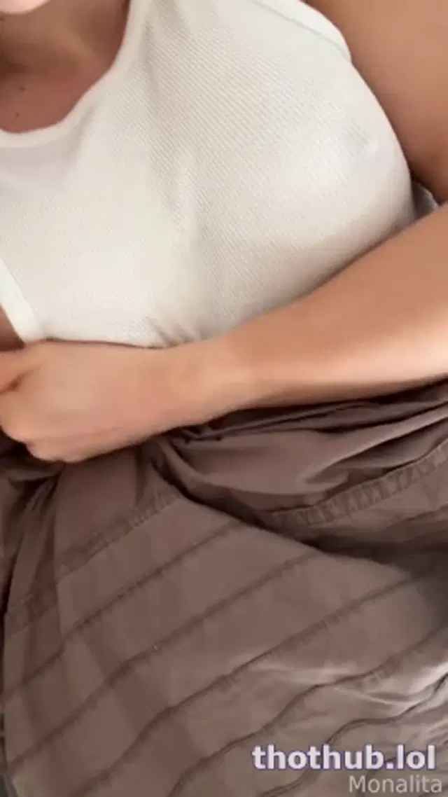 Monalita masturbating on bed in white top